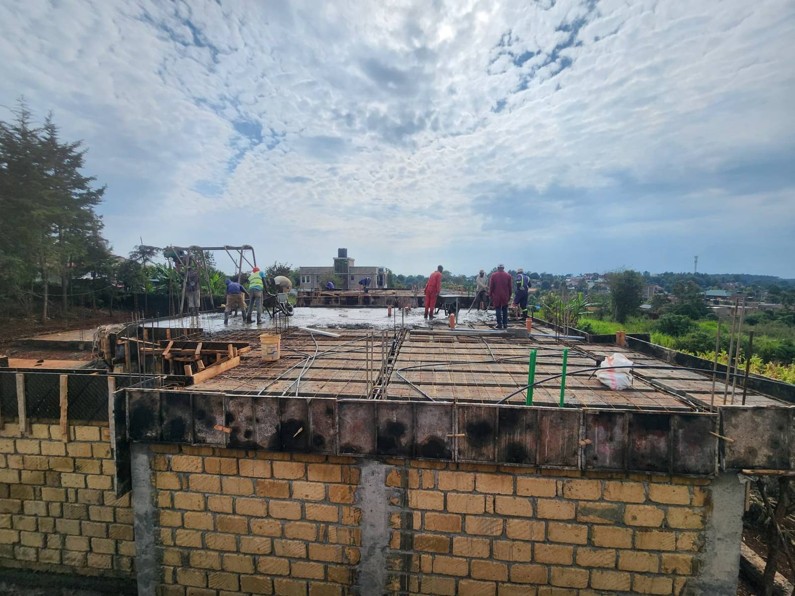 Concrete roof slab construction in progress on a T&T building site